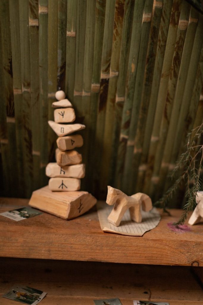 Wooden carved horse and rune stones on shelf