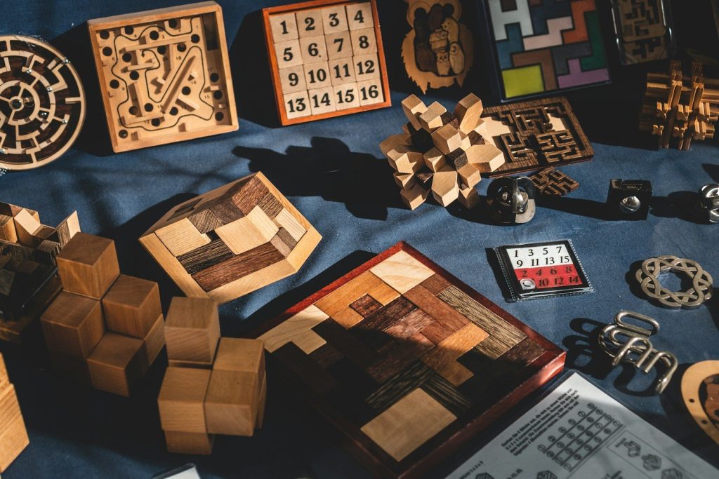 Natural brown wooden blocks on a blue textile background representing the raw materials for discovery