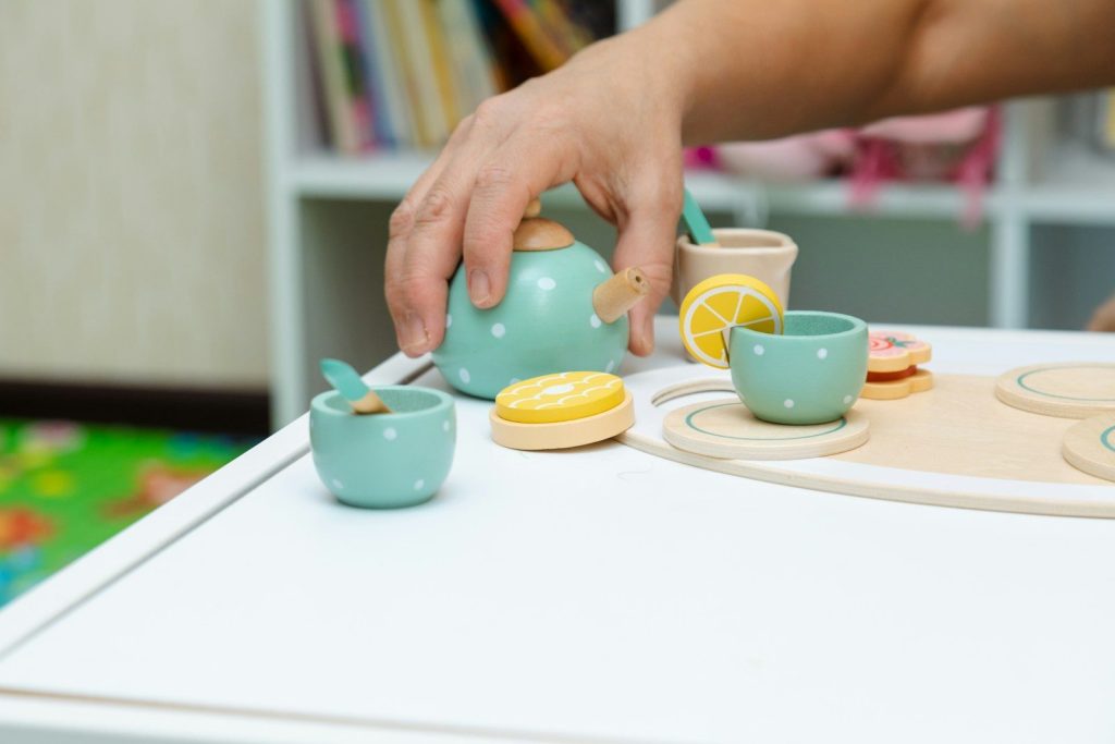 a person is putting a lemon in a teapot