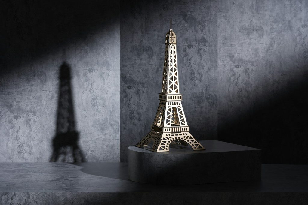 A beautifully assembled wooden 3D puzzle model of the Eiffel Tower