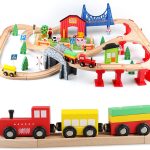 Child playing on the floor with a large ExpressTrack kids wooden train set