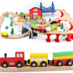 Child playing on the floor with a large ExpressTrack kids wooden train set
