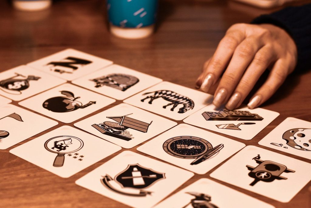 A person is playing a game of cards on a table