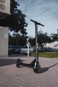 Close-up of a black kids kick scooter on a concrete path