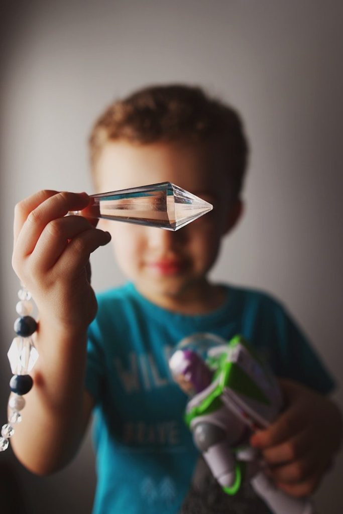 A young boy observing his science experiment with curiosity