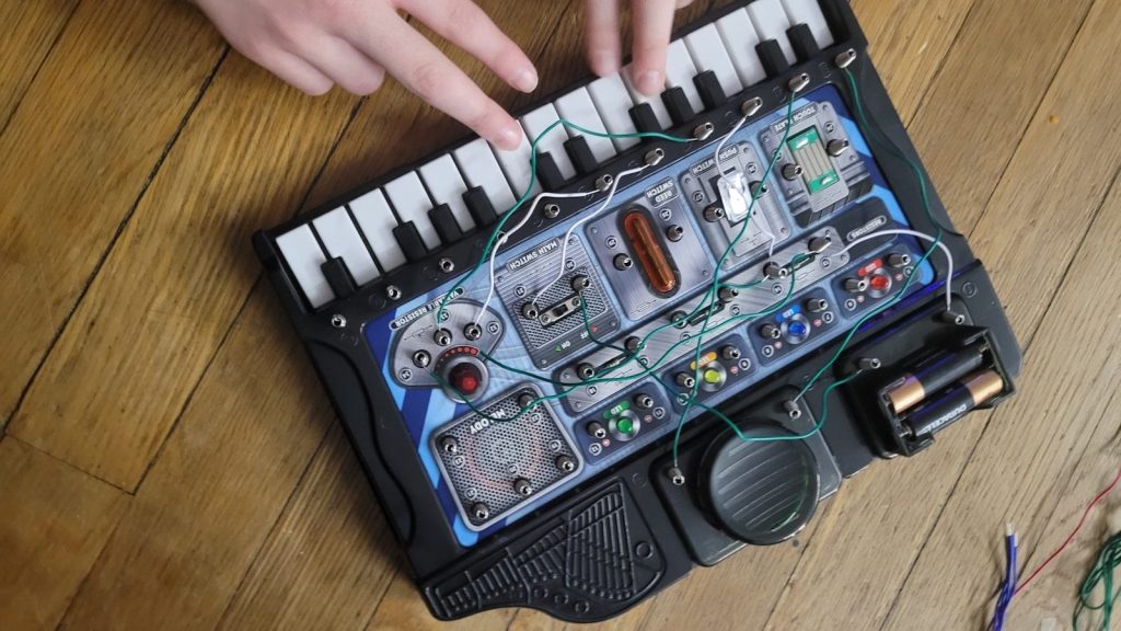 A young scientist exploring the basics of electricity with an electronics discovery kit