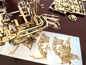 A wooden model of a mechanical device on a table
