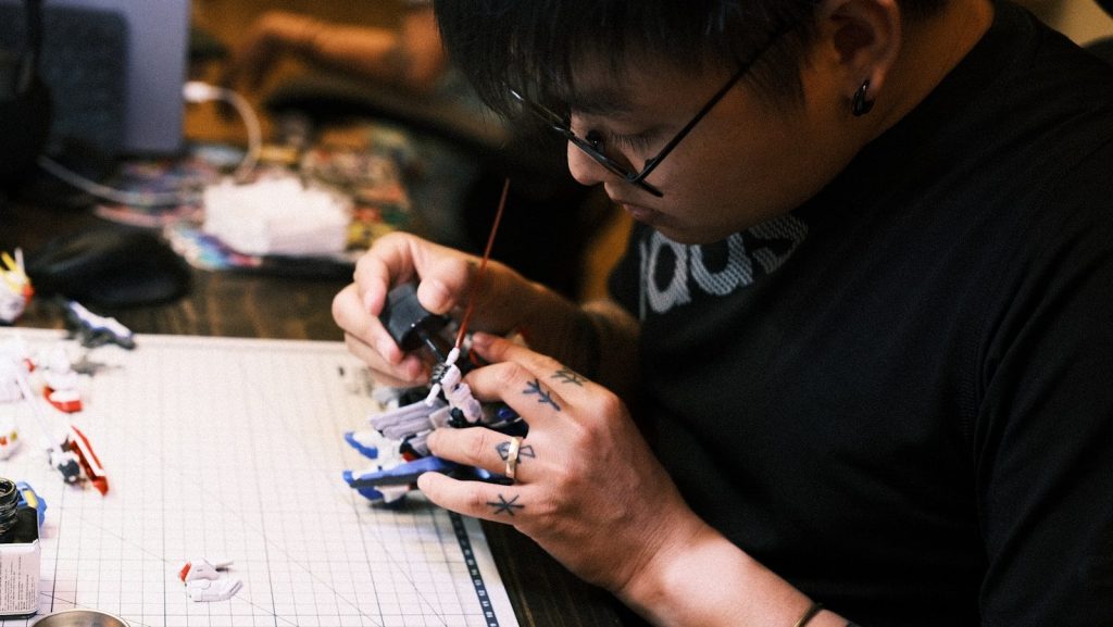 A young engineer meticulously assembling a solar-powered robotic module